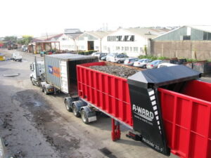 A-ward Mislide container tilter full of rubble