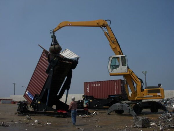 People working at a scrap yard with an A-Ward container loader