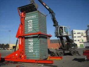 People working at a scrap yard with an A-Ward container loader