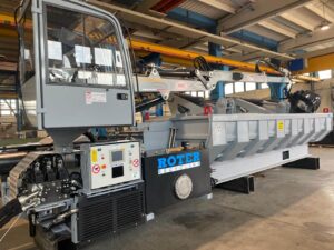 Landscape photo of a grey and blue roter car baler