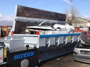 Roter car baler in operation at a scrapyard