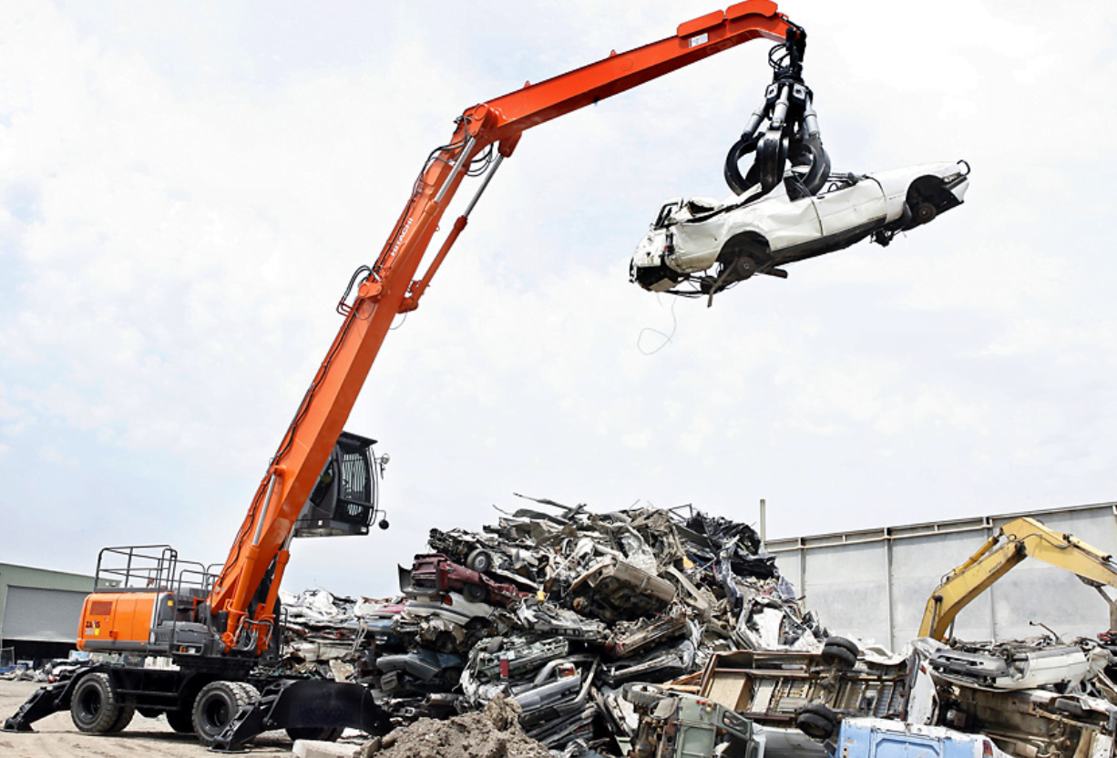 A recycling machine grabbing a car